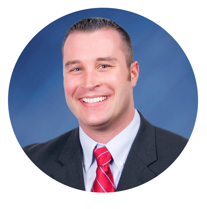 Headshot of the Banccard Representive at Kentucky Farmers Bank. He is smiling and wearing a black suit with a blue solid background.